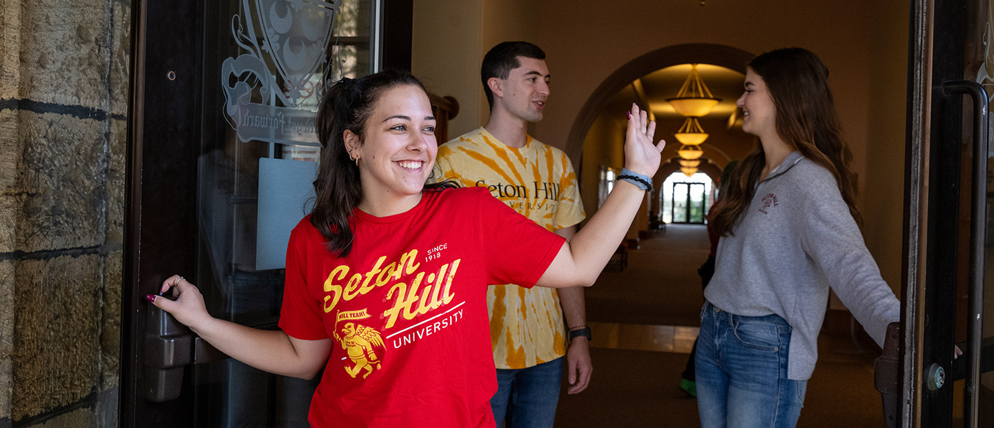 Students Holding Open Admin Door