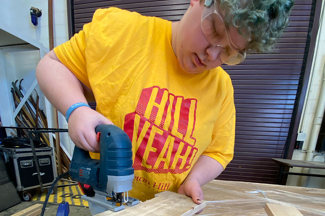 Photo of A Student Working With a Jigsaw