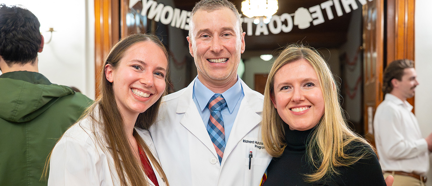 Three people smiling for a photo.