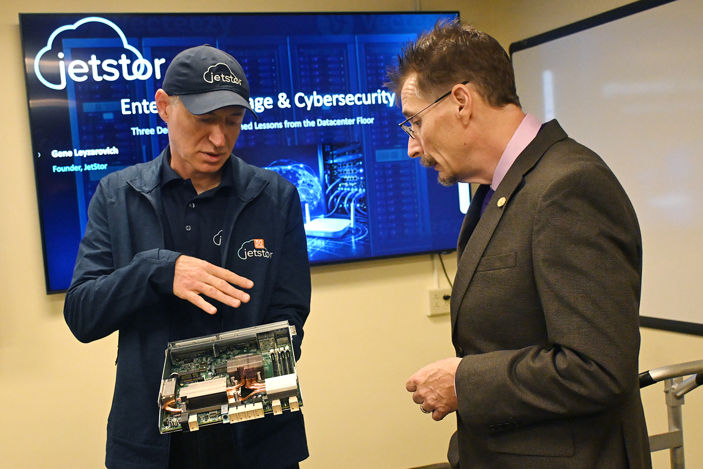 JetStor Founder Gene Leyzarovich and Dr. Matthew Kisow Associate Professor of Cybersecurity look at a donated JetStor storage system