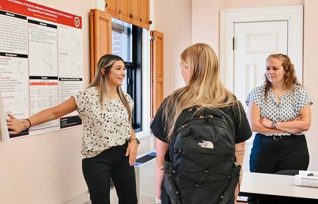 Student presenting research to students and faculty