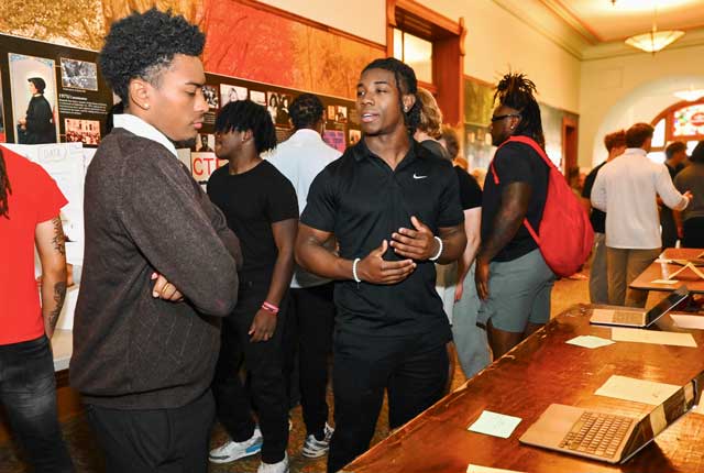 Student presenting research to fellow student