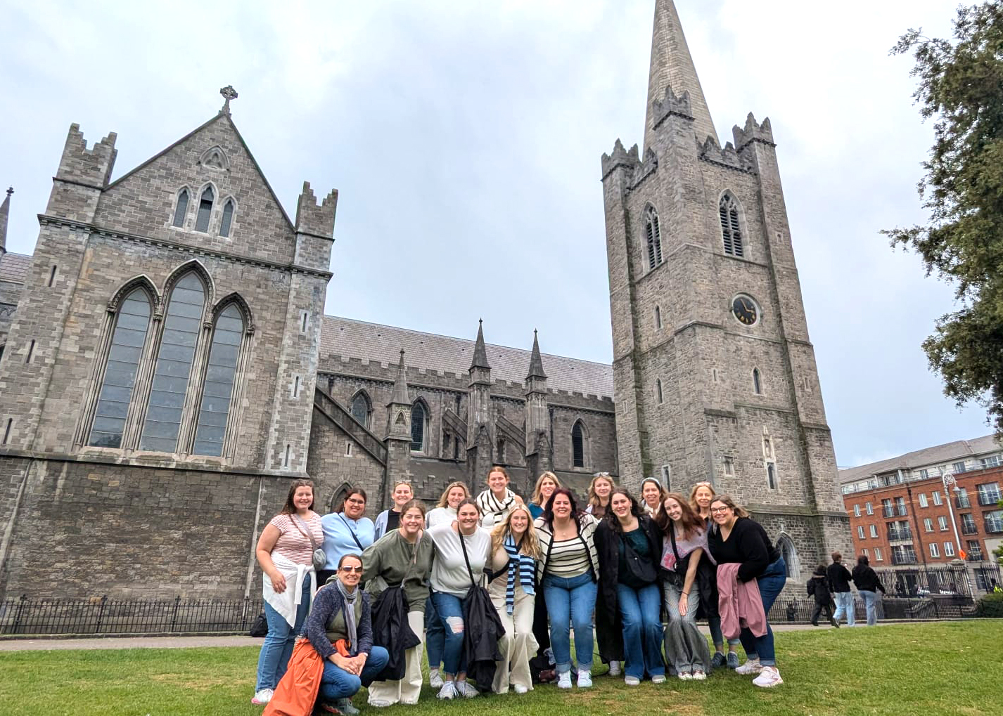 Group of people in front of a castle.