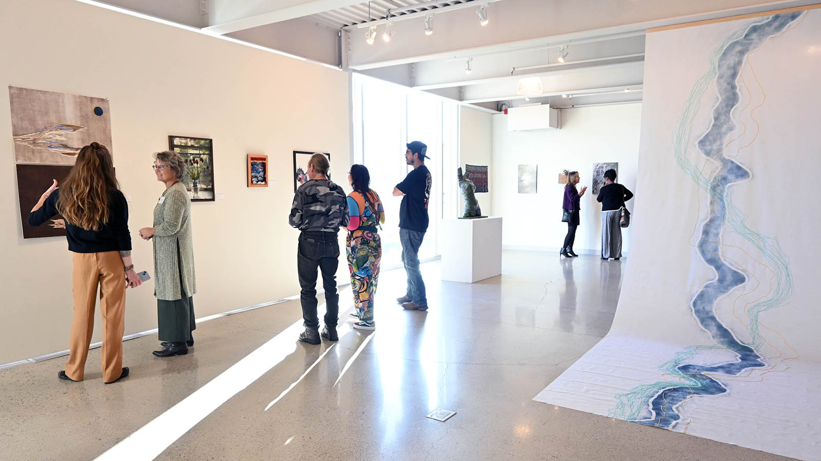 people viewing art in a gallery